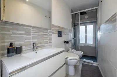 a white bathroom with a sink and a toilet at ht movie flat bilo in Rome