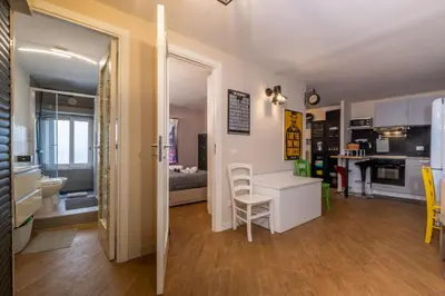 a kitchen and living room with a table and chairs at ht movie flat bilo in Rome