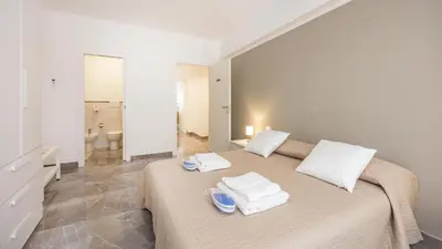 a bedroom with a large bed with towels on it at Rosina's House in Rome
