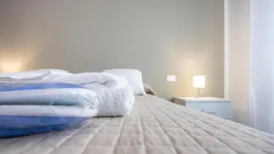 a bedroom with a bed with towels on it at Rosina's House in Rome