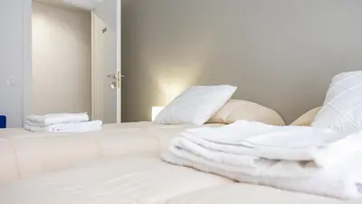 a room with a white bed with towels on it at Rosina's House in Rome