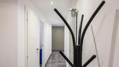 a hallway with a vase in the middle of a room at Rosina's House in Rome