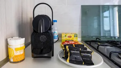 a kitchen counter top with a black appliance on it at Rosina's House in Rome