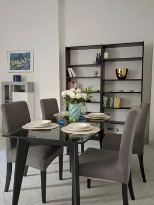 a dining room with a black table and chairs at Raffa al Pigneto in Rome
