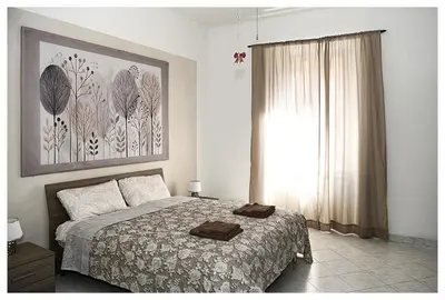 a bedroom with a bed and a large window at Raffa al Pigneto in Rome