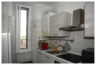 a small kitchen with a sink and a window at Raffa al Pigneto in Rome