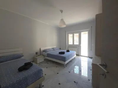 a bedroom with two beds and a window at Rome sweet home - Casa Cesari in Rome