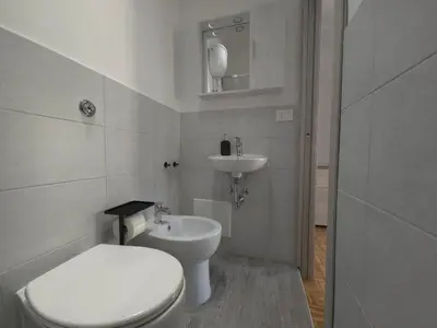 a white bathroom with a toilet and a sink at Rome sweet home - Casa Cesari in Rome