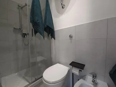 a bathroom with a shower and a toilet and a sink at Rome sweet home - Casa Cesari in Rome