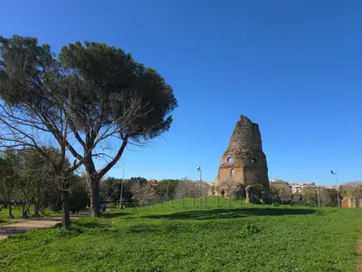 an old tower in a field with a tree at Rome sweet home - Casa Cesari in Rome
