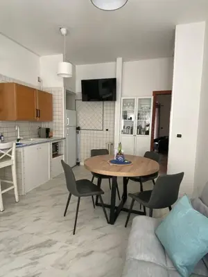 a kitchen and living room with a table and chairs at Ripa di Trastevere in Rome