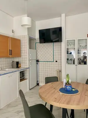 a kitchen and dining room with a table and chairs at Ripa di Trastevere in Rome