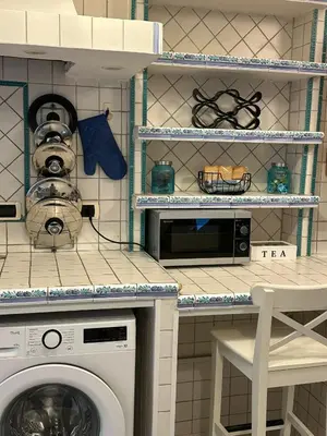 a kitchen with a washing machine and a table at Ripa di Trastevere in Rome