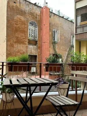 a picnic table on the balcony of a building at Ripa di Trastevere in Rome