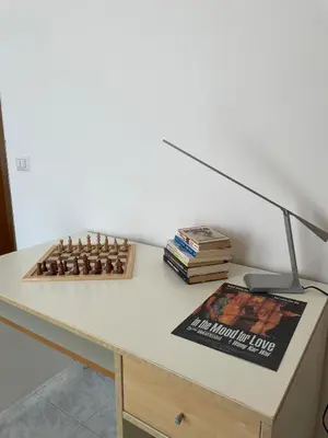 a desk with a lamp and a chess set on it at Casa cozy e luminosa - Tiburtina in Rome