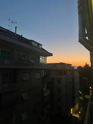 a view of a building with the sunset in the background at Casa cozy e luminosa - Tiburtina in Rome