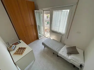 a room with a bed and a table and a window at Casa cozy e luminosa - Tiburtina in Rome