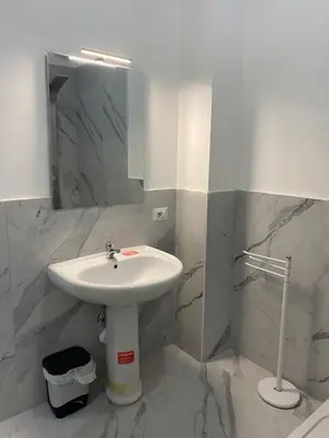 a white bathroom with a sink and a mirror at Scalia gest in Rome