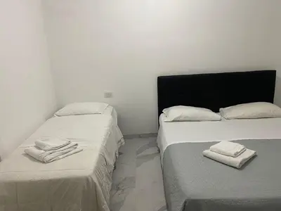 two beds sitting next to each other in a room at Scalia gest in Rome