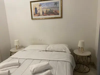 a bedroom with two beds and a picture on the wall at Scalia gest in Rome