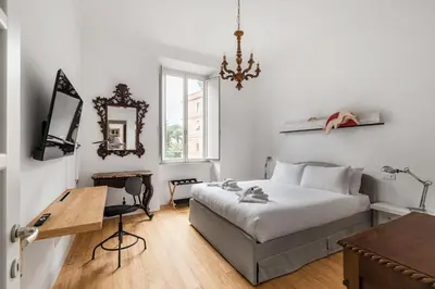 a bedroom with a bed and a desk and a mirror at Nauta Rome - Comfort e Design in Rome