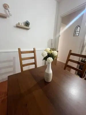 a vase of flowers sitting on a wooden table at Cupola Rooms Vicino al Vaticano in Rome