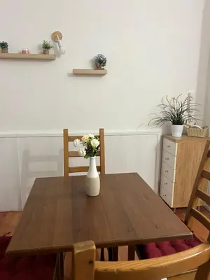 a wooden table with a vase of flowers on it at Cupola Rooms Vicino al Vaticano in Rome