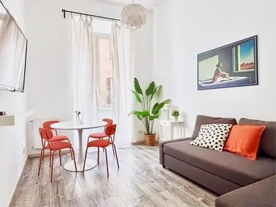 a living room with a couch and a table and chairs at DaliTourism - Colosseo Experience 28 in Rome