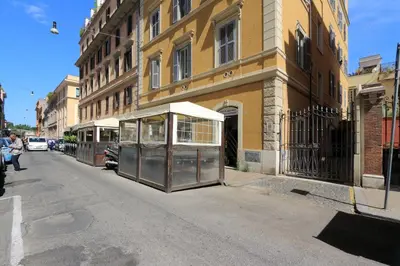 a bus stop on the side of a city street at DaliTourism - Colosseo Experience 28 in Rome
