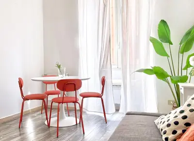 a dining room with a table and four chairs at DaliTourism - Colosseo Experience 28 in Rome