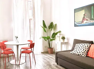 a living room with a table and a couch at DaliTourism - Colosseo Experience 28 in Rome