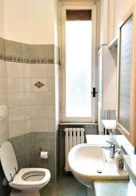 a bathroom with a toilet and a sink at Casa GattaMelata in Rome