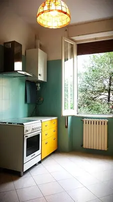 a kitchen with a white stove and a window at Casa GattaMelata in Rome