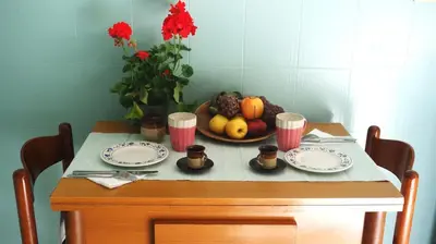 a table with two plates and a bowl of fruit at Casa GattaMelata in Rome
