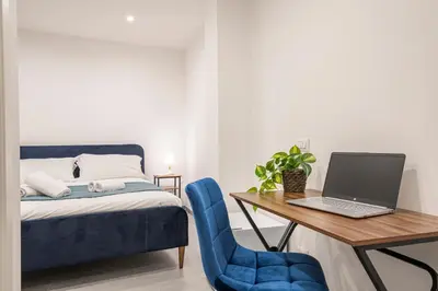 a bedroom with a bed and a desk with a laptop at Pallaro 6 room in Rome