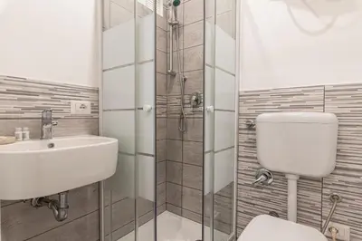 a bathroom with a toilet and a sink and a shower at Pallaro 6 room in Rome