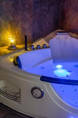 a white bath tub with a blue light in a bathroom at Aurelia Garden Suite in Rome