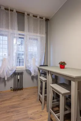 a dining room with two tables and a window at Aurelia Garden Suite in Rome