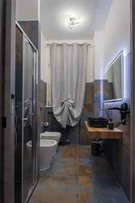 a bathroom with a toilet and a sink and a shower at Aurelia Garden Suite in Rome