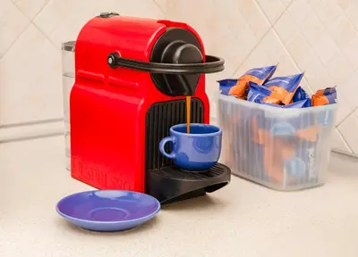 a red coffee maker with a cup on a counter at Azzurra Home in Rome