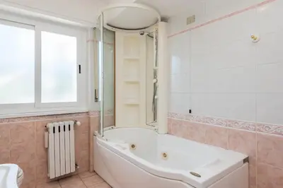 a bathroom with a bath tub and a window at Vatican-Metro A Panoramic Penthouse with Jacuzzi in Rome
