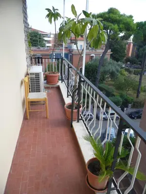 a balcony with a chair and potted plants at I Gerani in Rome
