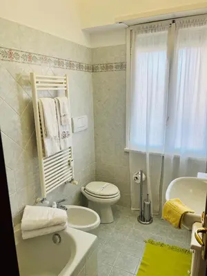 a bathroom with a toilet and a sink and a tub at I Gerani in Rome