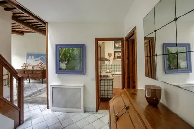 a living room with a table and a kitchen at Terrazza Altavista - Aeternum Urbe in Rome