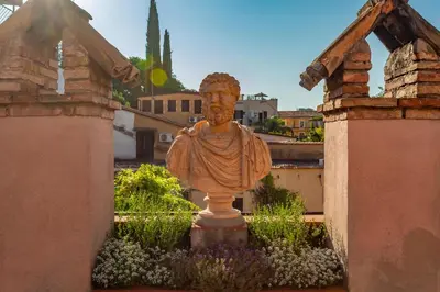 a statue of a bust of a man in a garden at Terrazza Altavista - Aeternum Urbe in Rome