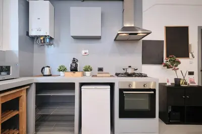 a kitchen with white cabinets and a stove at Vatican Charming Retreat by NDP rent in Rome