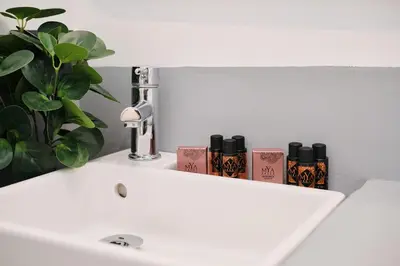 a bathroom sink with three candles and a plant at Vatican Charming Retreat by NDP rent in Rome