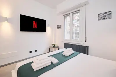 a bedroom with a large white bed with towels at Vatican Charming Retreat by NDP rent in Rome