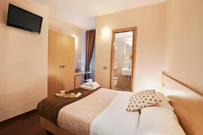 a hotel room with a bed and a bathroom at La Piccola Maison in Rome