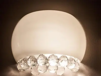 a white light fixture with diamonds on it at La Piccola Maison in Rome